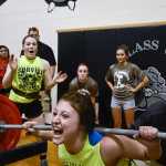 Photo by Rashah McChesney/Peninsula Clarion  Katie Costello, senior, attemps to squat 300 pounds Thursday March 27, 2014 during Speed, Strength Training compeition at Nikiski High School in Nikiski, Alaska. Costello said her max weight was 335.