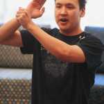 Photo by Kelly Sullivan/Peninsula Clarion Gabriel Stone kneels and briefly enacts a traditional dance at the Alaska Native Oratory Society, Friday, Marh 28, at Kenai Peninsula College.