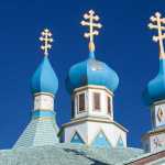 Photo by Rashah McChesney/Peninsula Clarion Father Thomas Andrew points to the louvers, or window blinds, that are installed in the Holy Assumption of the Virgin Mary Russian Orthodox Church's bell tower Friday April 11, 2014 in Kenai, Alaska. The tower will be refurbished as part of a $12,000 grant the church received from the Alaska Historical Commission.