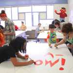 Photo by Kelly Sullivan/ Peninsula Clarion Almost 100 community members came out to help paint the Nikiski community mural on Friday and Saturday, April 11 and 12, at the Nikiski Recreation Center.