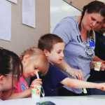 Photo by Kelly Sullivan/ Peninsula Clarion Elizabether, Bella, Noah and Kecia Hunter (left to right), came as a family to work on the Nikiski community mural, Friday and Saturday, April 11 and 12, at the Nikiski Recreation Center.
