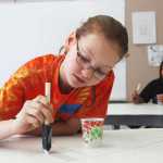 Photo by Kelly Sullivan/ Peninsula Clarion Anna Widman came up with the idea for a community inclusive mural, drawn by her art students at Nikiski high school and painted by community members on Friday and Saturday, April 11 and 12, at the Nikiski Recreation Center.