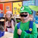 Photo by Rashah McChesney/Peninsula Clarion  Jayden Rodgers-Whipple, dressed as video game character Luigi, prepares to recite the Pledge of Allegiance Wednesday April 16, 2014 at Mountain View Elementary school in Kenai, Alaska. Students dressed up for "Character Day" at the school.
