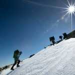 In this Friday, April 4, 2014 photo, climbers make their way up Mount Adams in New Hampshire. While mud season is underway at lower elevations, above the tree line, deep snow lingers well into spring in the White Mountains. (AP Photo/Robert F. Bukaty)