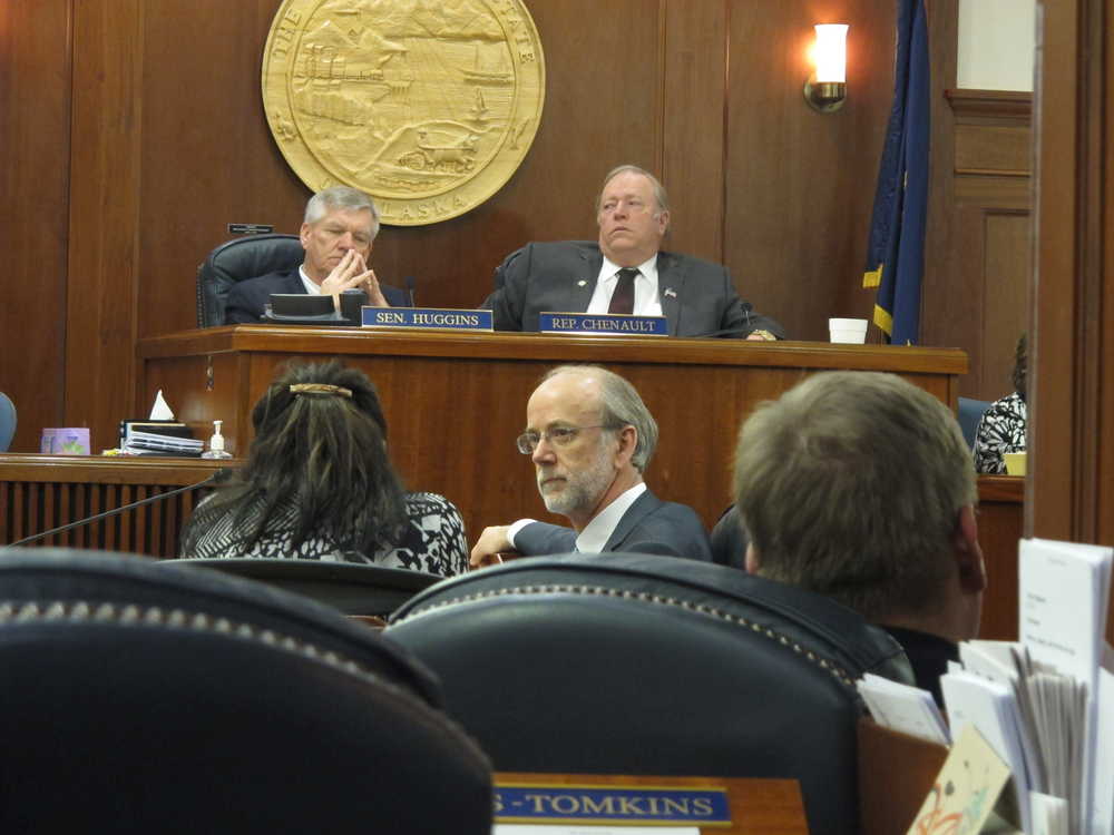Senate Minority Leader Hollis French, center, looks back as he listens to a speaker during debate on one of the governor's appointments during a joint legislative session on Thursday, April 17, 2014, in Juneau, Alaska. Shown on the dais in the background are Senate President Charlie Huggins, left, and House Speaker Mike Chenault. (AP Photo/Becky Bohrer)