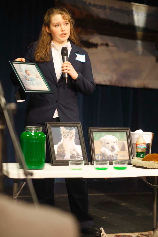 Photo by Kelly Sullivan/ Peninsula Clarion Volunteer Amelia Mueller takes ballots from the judges panel during the CFK 24th annual finalists competition, Thursday, April 17, at Kenai Central high school.