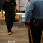 Photo by Kelly Sullivan/ Peninsula Clarion Officer Ronnie Simons gives resident Zach Moore a fake sobriety test during the Drunk Goggles presentation, Thursday, April 17, at the KPC Residence Hall.