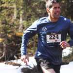 Photo by Kelly Sullivan/ Peninsula Clarion James Tangaro ran through muddy pools of melting ice on Wolverine trail, Saturday, April 19, at the Tsalteshi Trail.