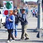Photo by Kelly Sullivan/ Peninsula Clarion Renee Lipps, Natalie Merrick and Elijah Stafford wave signs and pass out candy to raise awareness for the local launch of the Green Dot Violence Prevention Strategy, headed by LeeShore Center, Tuesday, April 22, on the Kenai Spur Highway.