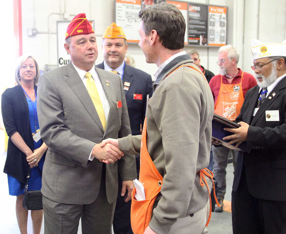 Photo by Dan Balmer/Peninsula Clarion American Legion National Commander Daniel Dillinger thanks Kenai Home Depot store manager Mark Pierson for the reserving a parking spot for veterans Thursday in Kenai. Dillinger, from Virginia, is in town for the 95th annual American Legion Alaska Department Convention from Thursday to Saturday at Post 20 in Kenai. American Legion dignitaries presented the store with a plague and a United States flag to show their appreciation for their support of veterans.