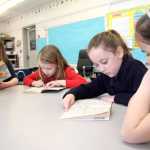 From left: Melanie Seater, Adelyn Pontius, Katie Nye and Adrianna Kindred, all Aurora Borealis Charter School second graders, read in a group at school on April 15 in Kenai. Photo by Kaylee Osowski/Peninsula Clarion