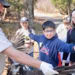 Photo by Rashah McChesney/Peninsula Clarion  Todd Eskelin, wildlife biologist, holds an eagle's wings open for Felix Lybarger compares himself to its wingspan and Jessica Croom looks on Saturday May 3, 2014 during a Youth Game Warden camp at the Kenai National Wildlife Refuge headwarters in Soldotna, Alaska.