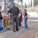 Photo by Rashah McChesney/Peninsula Clarion  United States Fish and Wildlife Service's Rob Barto tells a group of students at a Youth Game Warden camp about his yellow lab Rex and how Rex is used to find evidence of paching and illegal trafficking of wildlife Saturday May 3, 2014 at the Kenai National Wildlife Refuge headquarters in Soldotna, Alaska.