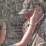Photo by Rashah McChesney/Peninsula Clarion  Dana Gibson brushes a mosquito off of Andy Loranger, Refuge Manager at the Kenai Wildlife Refuge, Saturday May 3, 2014 during a Youth Game Warden Camp at the refuge headquarters in Soldotna, Alaska.