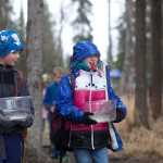 Photo by Rashah McChesney/Peninsula Clarion Jakob Murphy looks into Cadence Campbell's bucket as the two McNeil Canyon Elementary School third-graders carry rainbow trout down to Johnson Lake for release Tuesday May 6, 2014 in Kasilof, Alaska. The release was part of the Alaska Department of Fish and Game's annual Salmon Celebration.