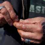 Photo by Rashah McChesney/Peninsula Clarion  Bill Schmidt, of Sterling, baits his hook Wednesday May 7, 2014 at Sport Lake in Soldotna, Alaska.