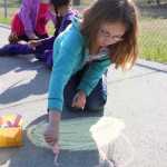 Photo by Kelly Sullivan/ Peninsula Clarion Trinity Murphy and her classmates in Shaya Straw's third grade Soldotna Middle School Elementary drew on the sidewalk while waiting for their turn to go a tour, Thursday, May 8, at the Soldotna Historic Post Office.