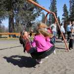 Photo by Dan Balmer/Peninsula Clarion Three girls swing while Cooper Every watches at Municipal Park Thursday. In the background, sisters Amber and Kristen Every along with Angie Cramer and Nicole Peterkin watch. The foursome who call themselves the Kenai moms, have been active in developing a proposal with the City of Kenai Parks and Recreation commission for two new playgrounds for both younger and older kids.