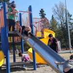 Photo by Dan Balmer/Peninsula Clarion Four children ages 5 and younger play on equipment intended for the 5-12 age group at Municipal Park Thursday. The equipment is more than 20 years old and the City of Kenai is considering a proposal to add playground equipment for ages 2-5 while also replacing the older playground.