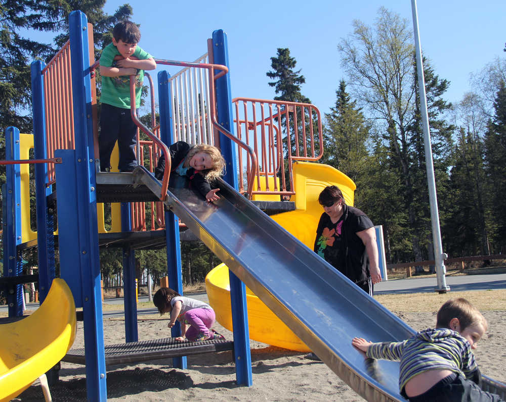 Photo by Dan Balmer/Peninsula Clarion Four children ages 5 and younger play on equipment intended for the 5-12 age group at Municipal Park Thursday. The equipment is more than 20 years old and the City of Kenai is considering a proposal to add playground equipment for ages 2-5 while also replacing the older playground.