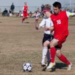 Photo by Rashah McChesney/Peninsula Clarion  Soldotna's 12 gets overtaken by Wasilla's 16 during their game Friday May 9, 2014 in Soldotna, Alaska.