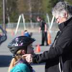 Photo by Kelly Sullivan/Peninsula Clarion Shelby Moore bought a helmet at the Bike Rodeo, and needed help adjusting the straps, Friday, May 9, at Mountain View Elementary School.