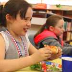 Photo by Kelly Sullivan/ Peninsula Clarion Rilee Erickson and Andi Hiler enjoy the lunch provided for the winners of this year's Reading Counts program, Friday, May 9, at Soldotna Elementary school.