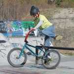 Photo by Will Morrow/Peninsula Clarion Duke Hardcastle lets go while performing a BMX stunt at the Karen Street skate and BMX park in Soldotna Monday.