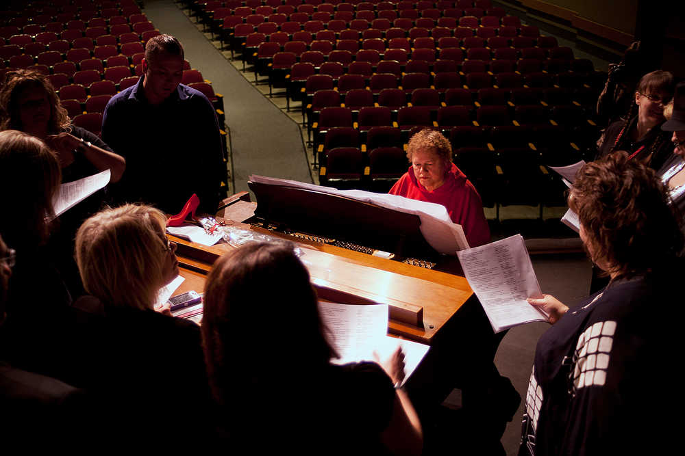 Photo by Rashah McChesney/Peninsula Clarion  Renee Henderson works with an alumni choir before her final Kenai Central High School choir concert Tuesday May 6, 2014 in Kenai, Alaska. Henderson, who has been teaching music at the high school for 43 years, will retire at the end of the 2013-14 school year.