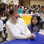 Photo by Rashah McChesney/Peninsula Clarion  Norma Holmgaard, retiring principal of Mountain View Elementary school, chats with a table of students during lunch Friday May 16, 2014 in Kenai, Alaska.