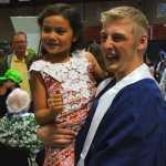 Photo by Dan Balmer/Peninsula Clarion Soldotna High graduate Malyq McElroy tilts his head back to show pictures of his mother he put on his cap at his graduation ceremony at the Regional Sports Complex Monday. His mother passed away when he was nine and raised by his grandmother Diane Ireland.