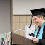 Jordan Fletcher, River City Academy graduate laughs during a speech at the school's graduation ceremony at the Soldotna Regional Sports Complex on Wednesday. Photo by Kaylee Osowski/Peninsula Clarion