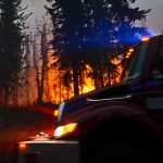 Photo by Rashah McChesney/Peninsula Clarion A firetruck provides water for crew on the ground as firefighters backburned near Funny River Road Wednesday May 21, 2014 in Soldotna, Alaska. Fire crews have been battling a wildfire that has grown to more than 44,000 acres in three days.