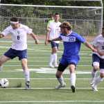 Homer's Mario Glosser, left, prepares to pass the ball to teammate Filip Ruetov during a 3-0 win over the Palmer Moose May 22 on the first day of the Northern Lights Conference Championships in Wasilla.