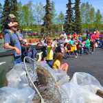 Photo courtesy Keith Baxter Friends and family who cleaned up the banks during the first annual Kenai River Spring Cleanup week, listen to the results of the groups, schools and individuals that picked up the most pounds of trash at the culminating barbecue and weigh-in, Saturday, May, 17, at Soldotna Creek Park.