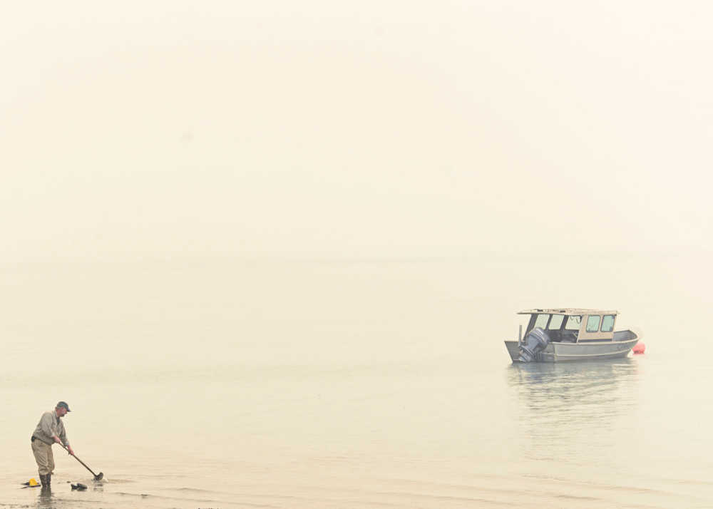 Photo by Rashah McChesney/Peninsula Clarion   A water scooper, commonly called a duck, plane drops fire retardent along a fire break near Royce Road Saturday May 24, 2014 in Funny River, Alaska.