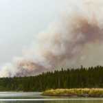 Photo by Rashah McChesney/Peninsula Clarion  A team of firefighters stands on the north shore of Tustumena Lake near the Bear Creek remote access subdivision Friday May 23, 2014 in the Kenai National Wildlife Refuge. Crews said the nearly 70,000 acre Funny River Trail wildfire was burning within a mile of the cabins and several homeowners were hand to pump water onto their properties.