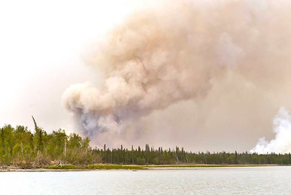 Photo by Rashah McChesney/Peninsula Clarion  Ash and debris coats the water on the north shore of Tustumena Lake where the Funny River Horse Trail fire has is burning close to several cabins in the remote Bear Creek subdivision Friday May 23, 2014 in the Kenai National Wildlife Refuge.