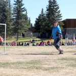 Katie Moon takes her dog, Lucy, through an agility course Tuesday, May 20, as students from Kalifornsky Beach Elementary School in Soldotna watch. Photo by Kaylee Osowski/PeninsulaClarion