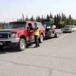 Victor Hett with the Kenai Peninsula Borough Community Emergency Response Team assists an evacuee from the Funny River Road area on Sunday at the Soldotna Regional Sports Complex. The Borough Office of Emergency Response asked residents from Mile 7 to Fisherman's Road to evacuate Sunday afternoon. Photo by Kaylee Osowski/Peninsula Clarion