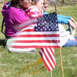 Photo by Kelly Sullivan/Peninsula Clarion Mandy Pieh, daughter Rebekah Pieh and son Josh Pieh sat close together in the brisks winds blowing during the Memorial Day service, Monday, May 26, at Soldotna Community Memorial Park.