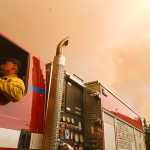 Photo by Rashah McChesney/Peninsula Clarion Central Emergency Services firefighter Dan Jensen acts as a firewatch under the haze of smoke from the Funny River Horse Trail wildfire Monday May 26, 2014 in Soldotna, Alaska.