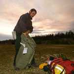 Photo by Rashah McChesney/Peninsula Clarion  Timofey Kolosov, firefighter from Delta Junction, sets up a tent in the Skyview High School soccer field Monday May 26, 2014 in Soldotna, Alaska. Kolosov and his crew arrived to help fight the Funny River Horse Trail wildfire which has burned more than 176,000 acres of Kenai National Wildlife Refuge land.