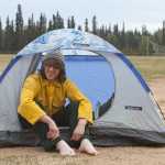 Photo by Rashah McChesney/Peninsula Clarion Firefighter Cristian Holder-Gauthier, of Fairbanks, sits in his tent in the Skyview High School parking lot as his crew from Delta Junction finishes setting up camp Monday May 26, 2014 in Soldotna, Alaska. Several hundred firefighters are camping on the Kenai Peninsula as they work to the contain the more than 176,000 acre Funny River Horse Trail wildfire.