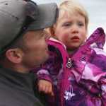 Photo by Kelly Sullivan/ Peninsula Clarion Jan Slegers holds his daughter Drew Slegers, whose mother had her while she was suffering from Neuroenodcrine Tumor cancer, Friday, May 30, at the Central Peninsula Relay for Life.