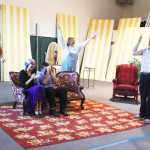 Photo by Kelly Sullivan/Peninsula Clarion The cast of the Kenai Performers production of Leading Ladies end the evening rehearsal with a laugh, May 28, on Kalifornsky Beach.