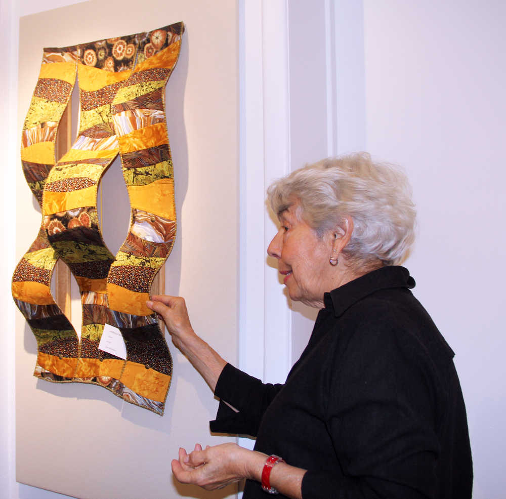Photo by Dan Balmer/Peninsula Clarion Marilyn Kay Johnson examines a 3-D quilt made by Jan Wallace at the Kenai FIne Arts Center Wednesday, two days before the opening of the Quilt Art Show in Kenai.