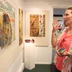Photo by Kelly Sullivan/ Peninsula Clarion Laurie Marta reacts to Sandra Sterling's quilt piece that incorporates silk and dying to create a three dimensional effect, June 6, at the Kenai Fine Arts Center.