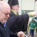 Photo by Rashah McChesney/Peninsula Clarion  Mike McBride holds a container of holy water for Bishop David Mahaffey during the bishop's blessing of a new outbuilding at the Holy Assumption of the Virgin Mary Russian Orthodox Church Thursday June 12, 2014 in Kenai, Alaska.