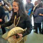 Photo by Rashah McChesney/Peninsula Clarion  Bunny Swan-Gease helps to complete a large circle of people during a cloth-tearing ceremony to commemorate the grand opening of the Kenaitze Indian Tribe's Dena'ina Wellness Center Thursday June 12, 2014 in Kenai, Alaska.